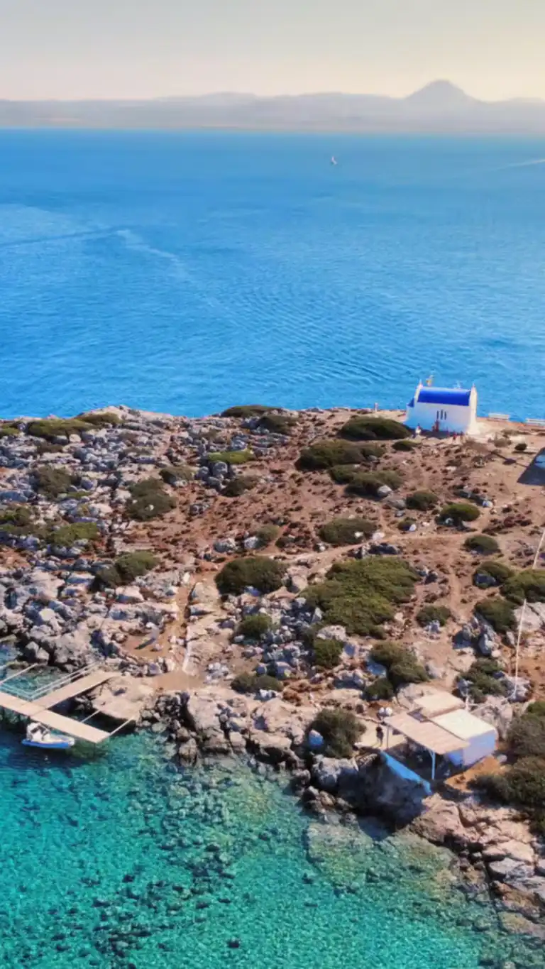 Aerial view of Dia Island near Heraklion with crystal-clear waters and rocky coastline, a destination for luxury sailing cruises